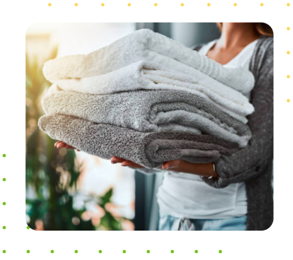 Woman holding clean, fresh, wash, dried, and folded towels from wash and fold service