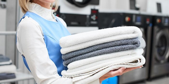 Woman carrying out towels